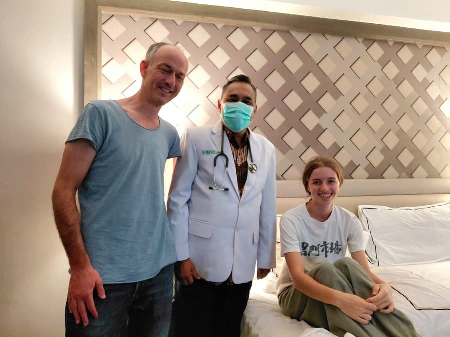 A Mitra 911 doctor with two international guests after a room visit at their hotel in Yogyakarta